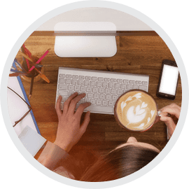 Modern workspace with keyboard, coffee, and tech devices at Sydney Web Experts.